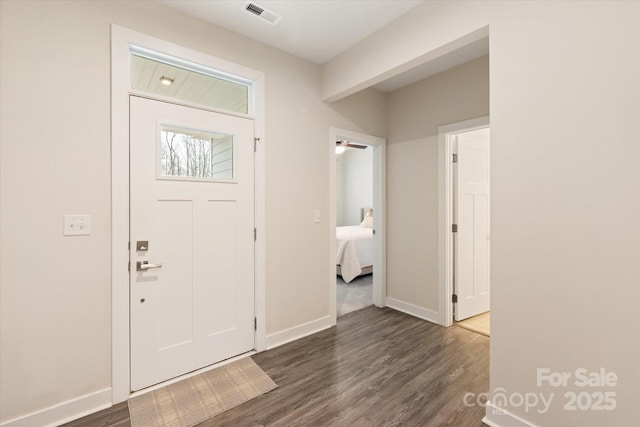 entryway featuring dark wood-style flooring, visible vents, and baseboards