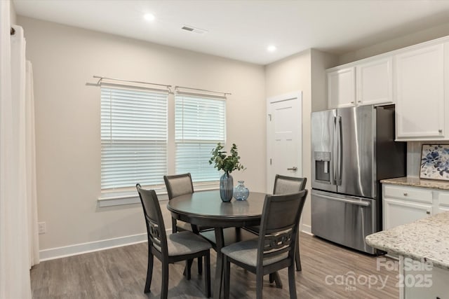 dining area featuring light wood-style floors, visible vents, baseboards, and recessed lighting