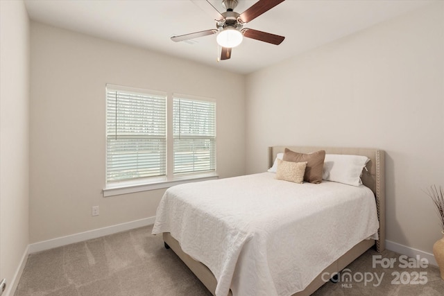 carpeted bedroom with ceiling fan and baseboards