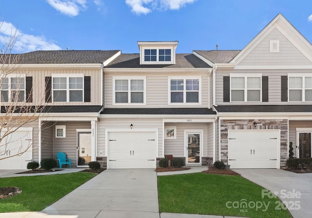 view of property featuring a front lawn and a garage