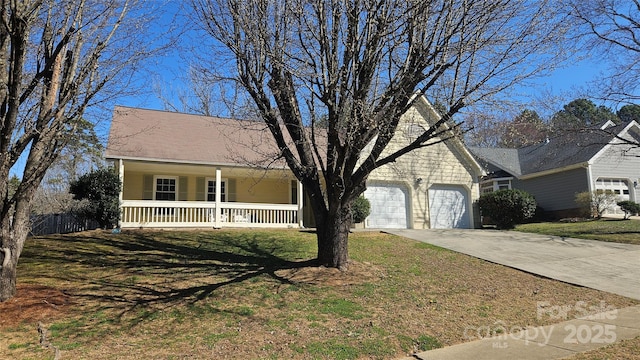 view of front of property featuring a garage, covered porch, driveway, and a front lawn