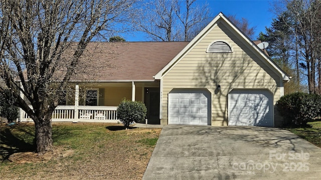 view of front of property with a garage, driveway, and a porch