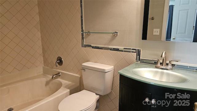 full bathroom featuring tub / shower combination, vanity, toilet, and tile walls