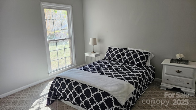 bedroom featuring baseboards and carpet flooring