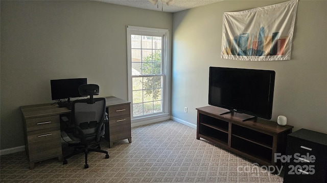 office space with a textured ceiling, baseboards, and carpet flooring