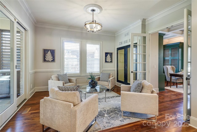 living room featuring an inviting chandelier, french doors, dark wood-type flooring, and ornamental molding