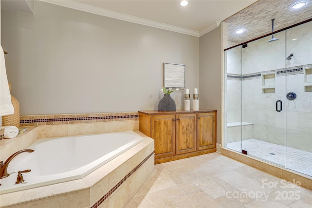 bathroom featuring ornamental molding and independent shower and bath