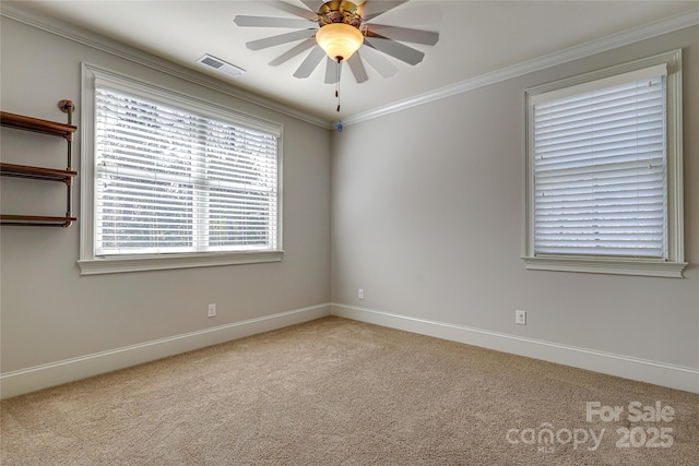 carpeted spare room featuring ceiling fan and crown molding