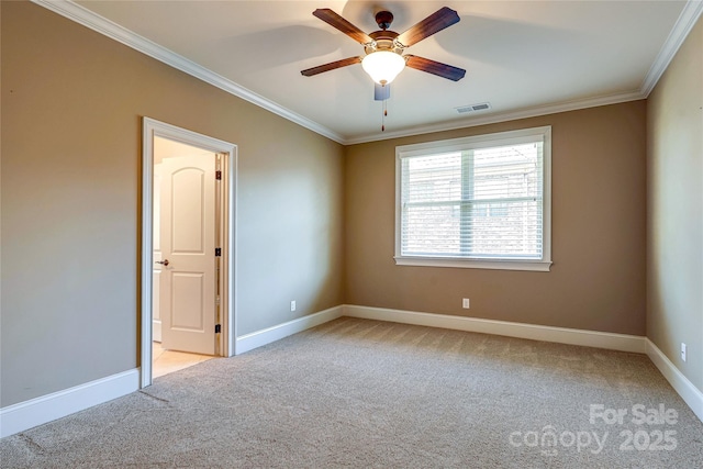 carpeted spare room with ceiling fan and crown molding