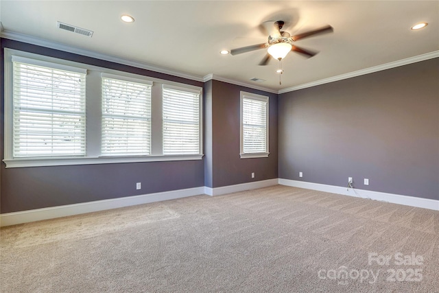 carpeted spare room featuring ceiling fan and crown molding