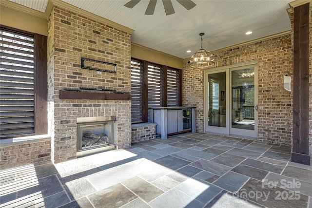 view of patio featuring an outdoor brick fireplace and ceiling fan