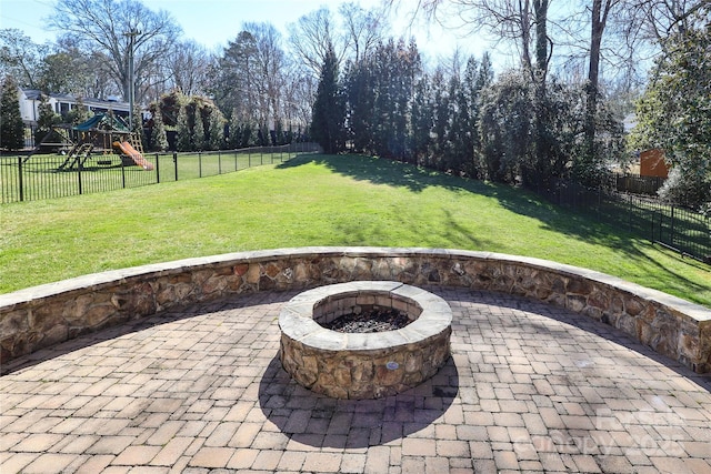 view of patio featuring a playground and a fire pit