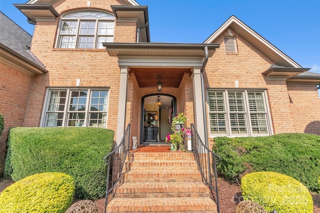 doorway to property with brick siding