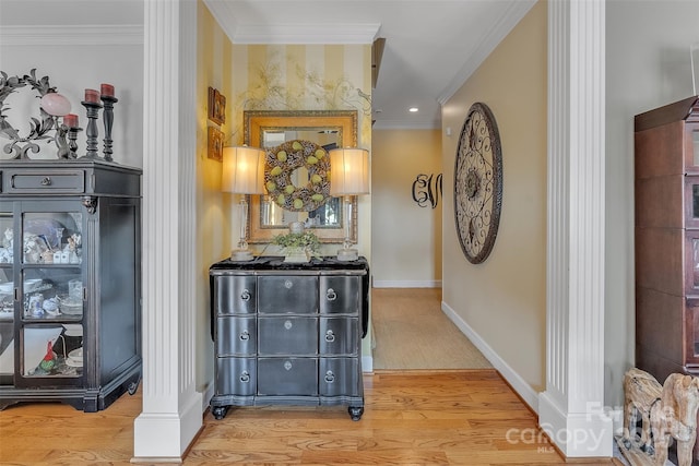 hallway with ornamental molding, baseboards, and wood finished floors