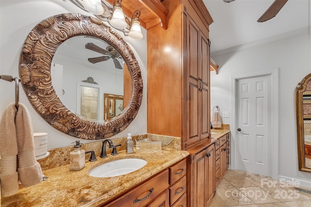 full bath featuring ceiling fan, ornamental molding, and vanity