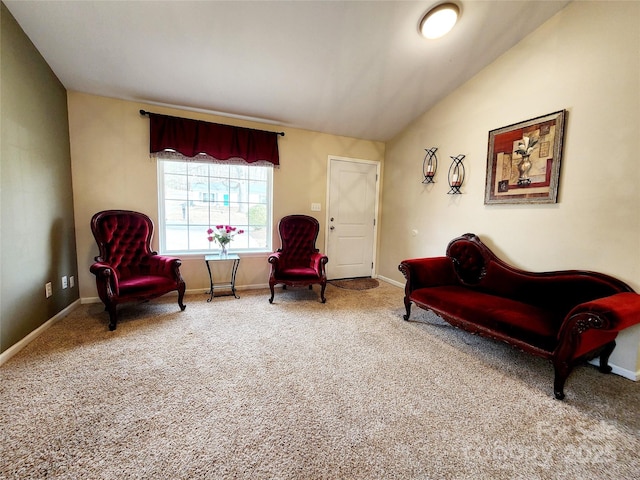 sitting room with vaulted ceiling, carpet, and baseboards