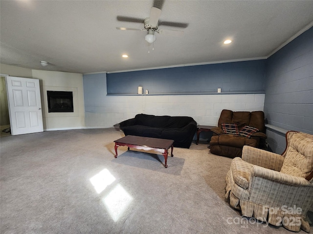 living room featuring ceiling fan, concrete block wall, and recessed lighting