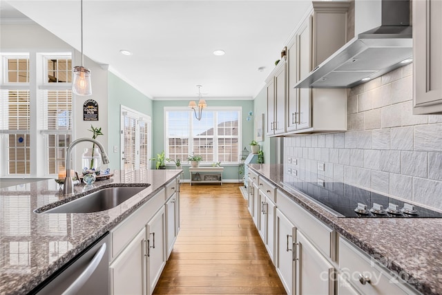 kitchen with black electric cooktop, a sink, dishwasher, wall chimney exhaust hood, and crown molding