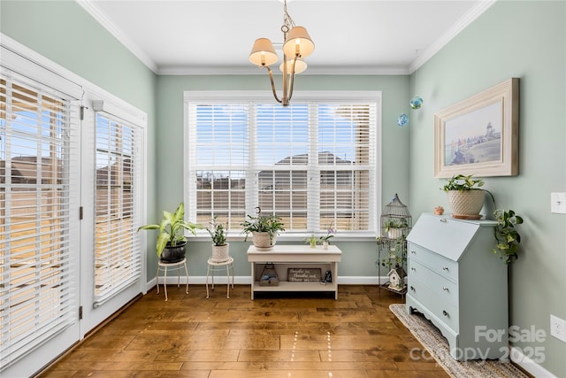 living area with ornamental molding, wood-type flooring, plenty of natural light, and baseboards