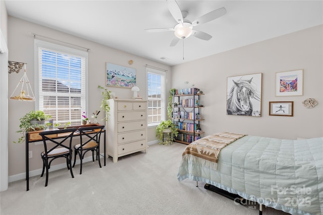 carpeted bedroom with a ceiling fan, visible vents, and baseboards