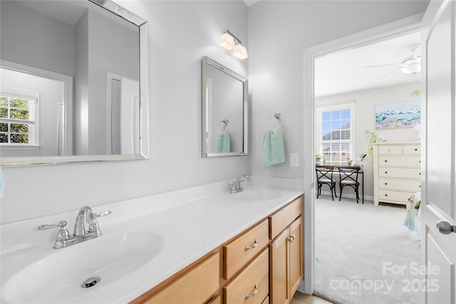 bathroom featuring double vanity, plenty of natural light, and a sink