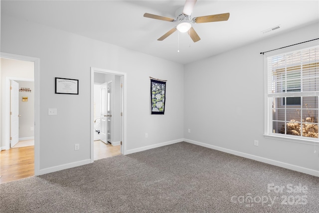 unfurnished bedroom featuring a ceiling fan, carpet, visible vents, and baseboards