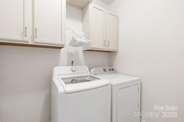 laundry area with cabinet space and washer and dryer