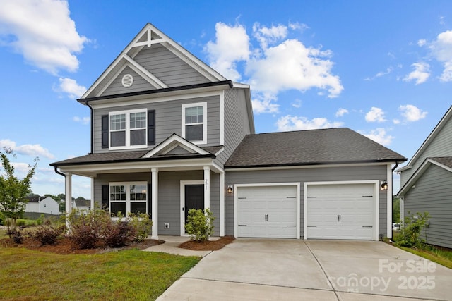 view of front of house with a porch, a garage, and a front yard