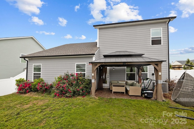 rear view of property featuring outdoor lounge area, cooling unit, a gazebo, and a lawn