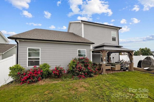 back of property with a patio, an outdoor hangout area, a yard, and a gazebo