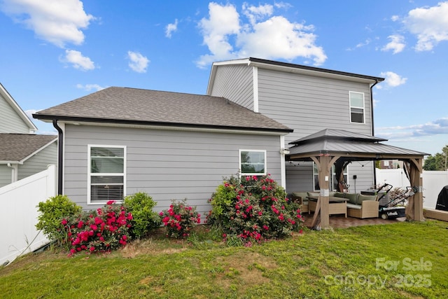 rear view of house featuring an outdoor hangout area, a yard, and a gazebo