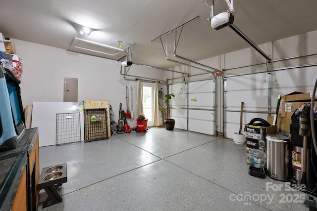 garage with a garage door opener and electric panel