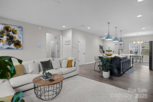 201 Bennett Trail Dr, Mount Holly, NC 28120 - living area with dark wood-style floors, recessed lighting, baseboards, and a chandelier