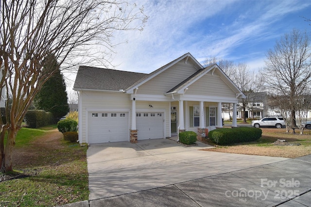 craftsman-style home with roof with shingles, an attached garage, and driveway