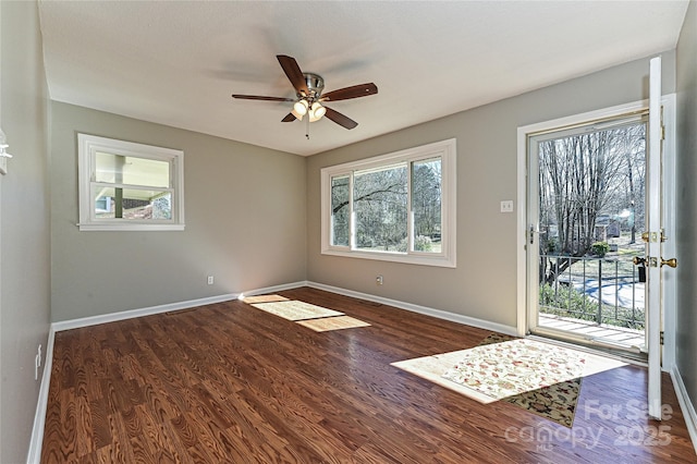 empty room with ceiling fan and dark hardwood / wood-style floors