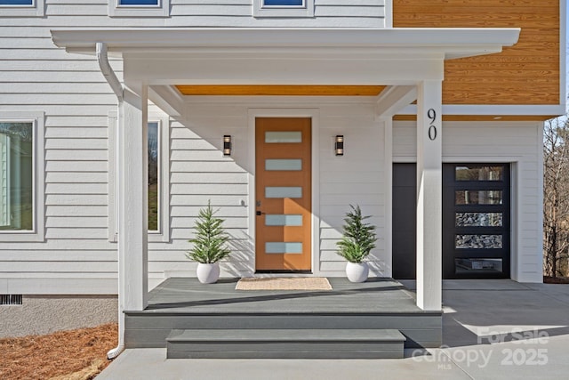view of exterior entry with covered porch