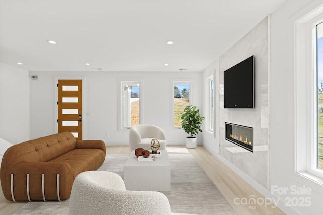 living area featuring plenty of natural light, a fireplace, and recessed lighting