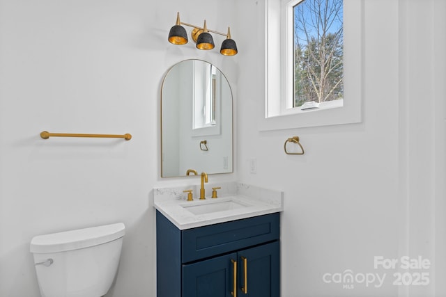 bathroom featuring toilet and vanity