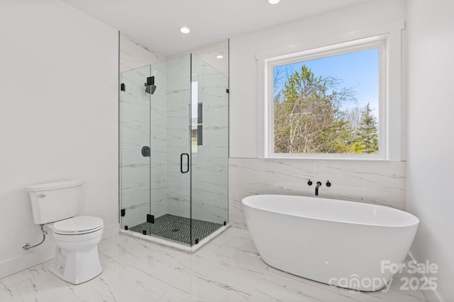 bathroom featuring toilet, a marble finish shower, marble finish floor, recessed lighting, and a freestanding tub