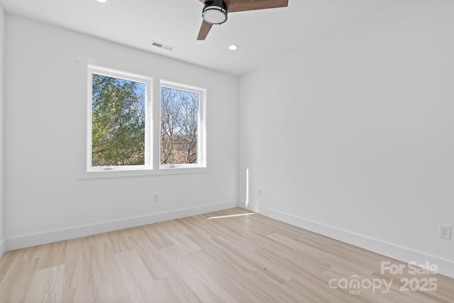 spare room with a ceiling fan, light wood-style flooring, recessed lighting, baseboards, and visible vents