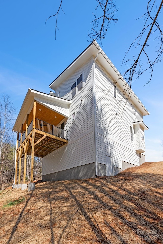 back of house featuring a wooden deck