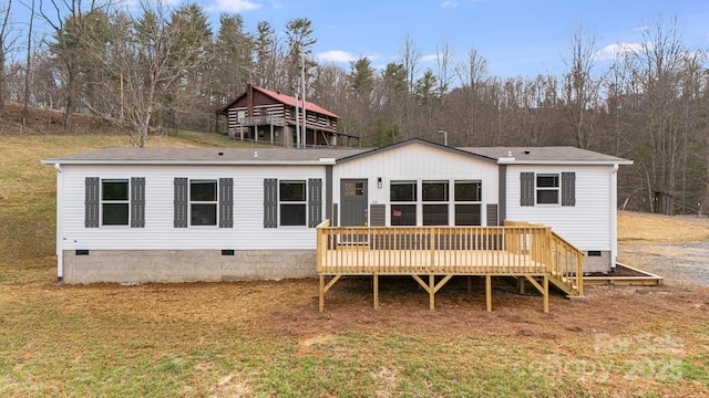 back of property with a yard, crawl space, and a wooden deck