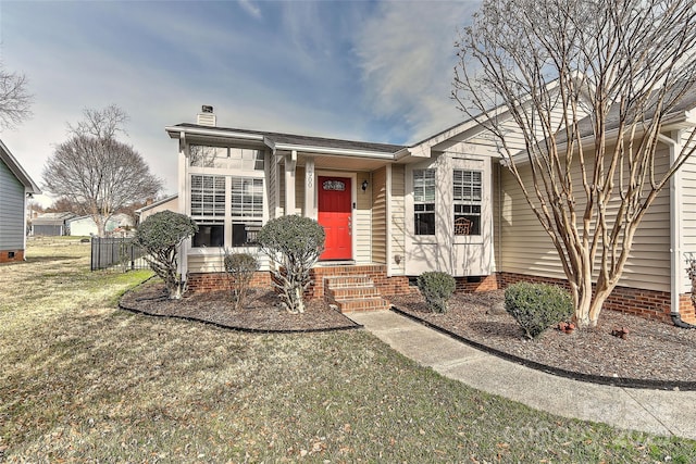 ranch-style house with crawl space, a chimney, fence, and a front lawn