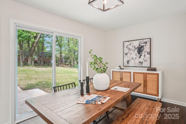 dining area with wood finished floors and baseboards