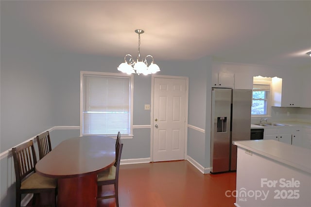 6126 Eagle Peak Dr, Charlotte, NC 28214 - dining area with baseboards and a notable chandelier