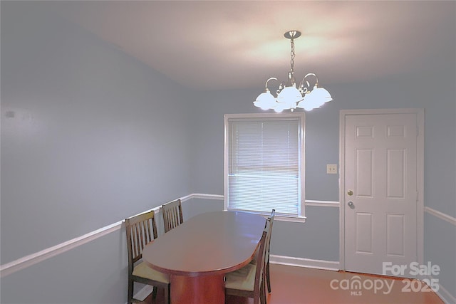 6126 Eagle Peak Dr, Charlotte, NC 28214 - dining space featuring a chandelier and baseboards