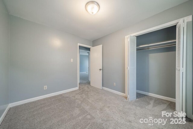6126 Eagle Peak Dr, Charlotte, NC 28214 - unfurnished bedroom featuring carpet, a closet, and baseboards