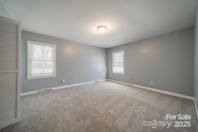 6126 Eagle Peak Dr, Charlotte, NC 28214 - spare room with visible vents, carpet flooring, and baseboards