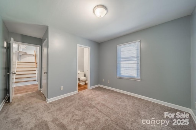 6126 Eagle Peak Dr, Charlotte, NC 28214 - unfurnished bedroom featuring baseboards, carpet flooring, and ensuite bathroom