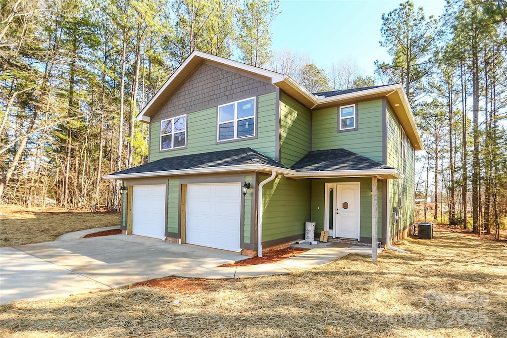 front of property featuring a garage and central AC unit